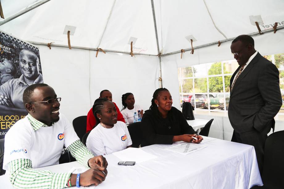 The Cabinet Secretary for Health, Dr. Cleopa Mailu engages some of the health workers conducting the exercise at Afya House