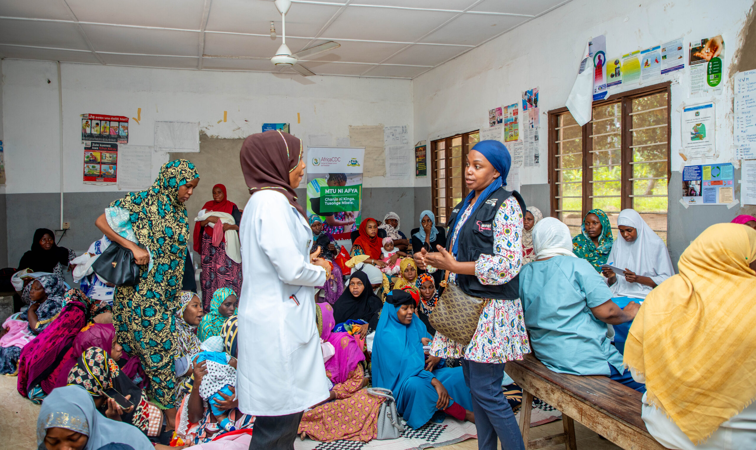 Shemsa Ramadhani (left), a health provider and data officer at Selem Health Centre in Zanzibar, engages with Amina Sufian, Amref Tanzania Regional Project Officer (Zanzibar), on using digital tools to strengthen vaccination tracking and improve community care.
